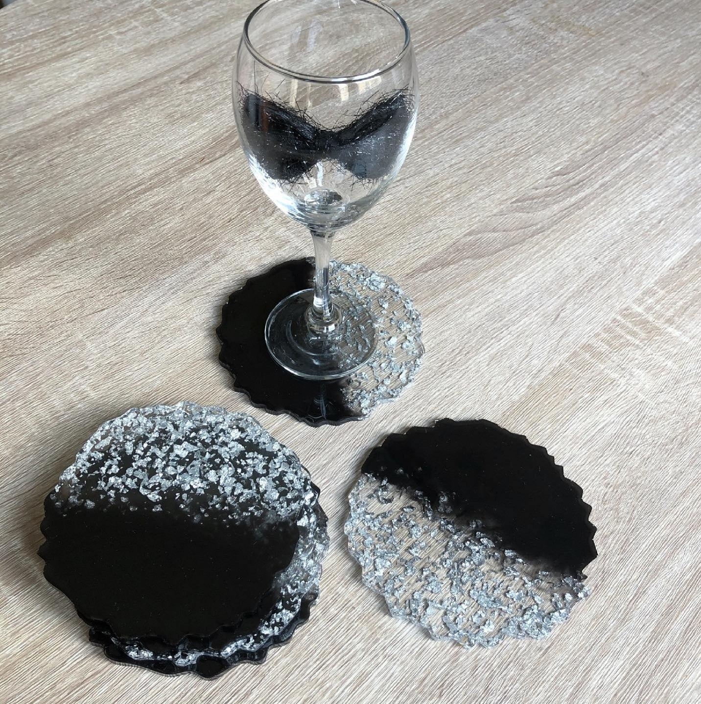 Black Pearl Radiance: Individual Black Resin Coaster with Silver Leaves - Geode Shape - 5in