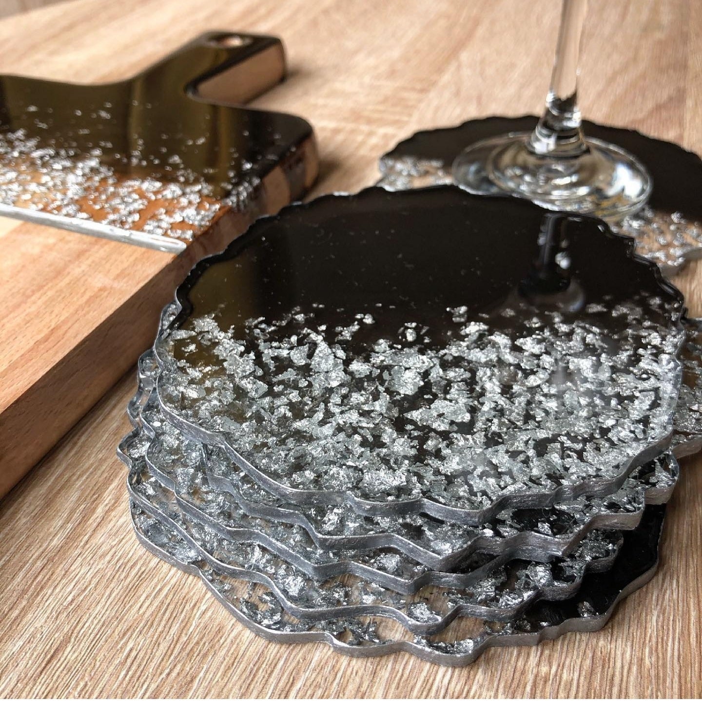 Black Pearl Radiance: Individual Black Resin Coaster with Silver Leaves - Geode Shape - 5in